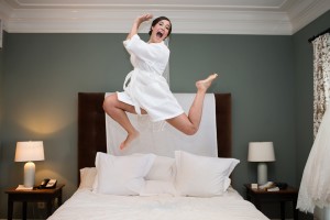 bride jumping on bed