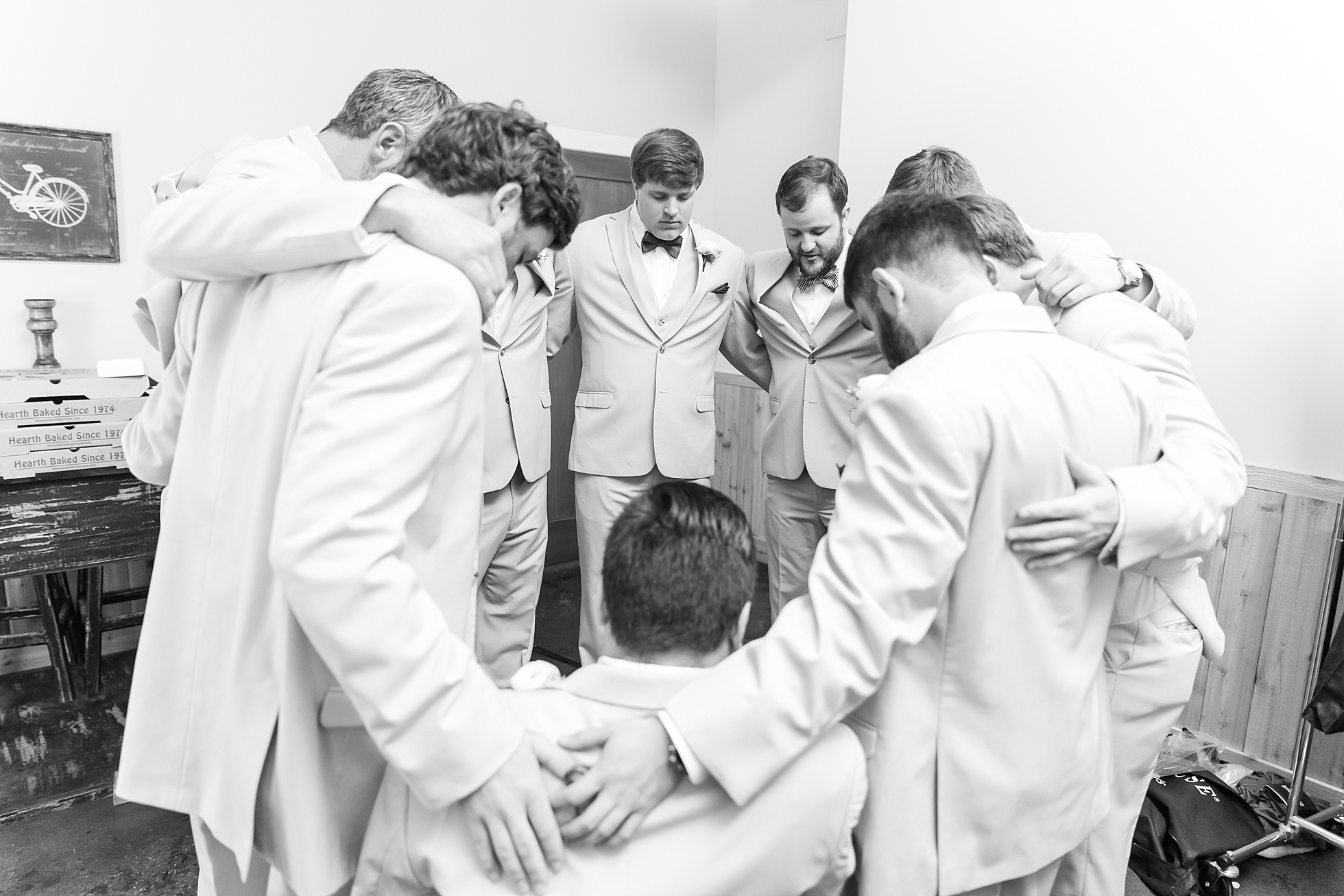 groomsmen praying before ceremony