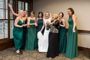 wedding bridesmaids champagne popping