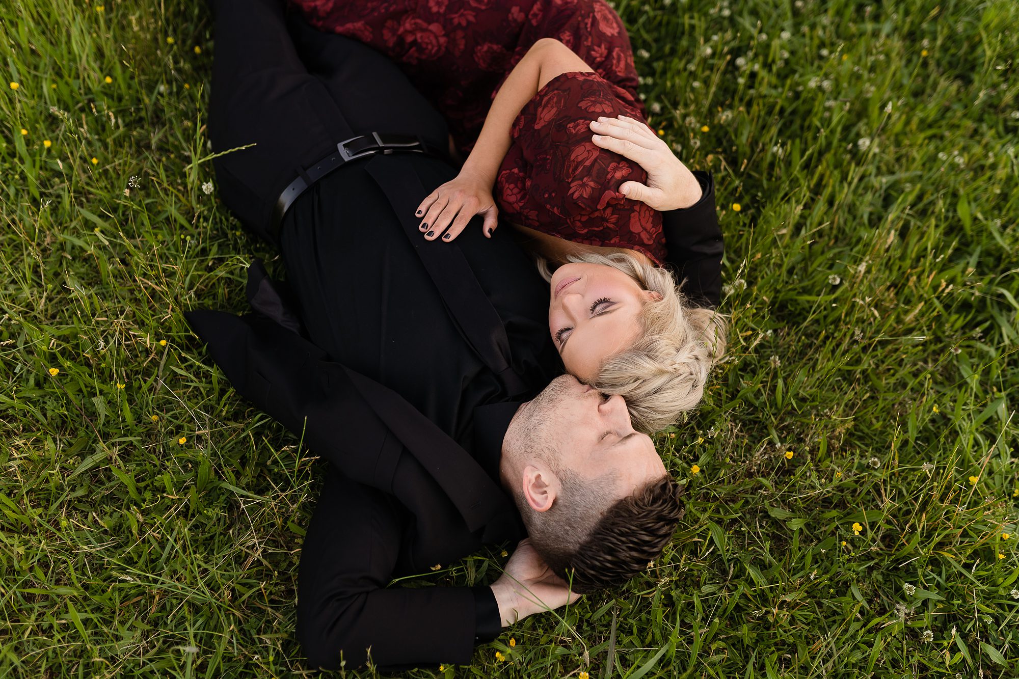 couple laying in a field of grass