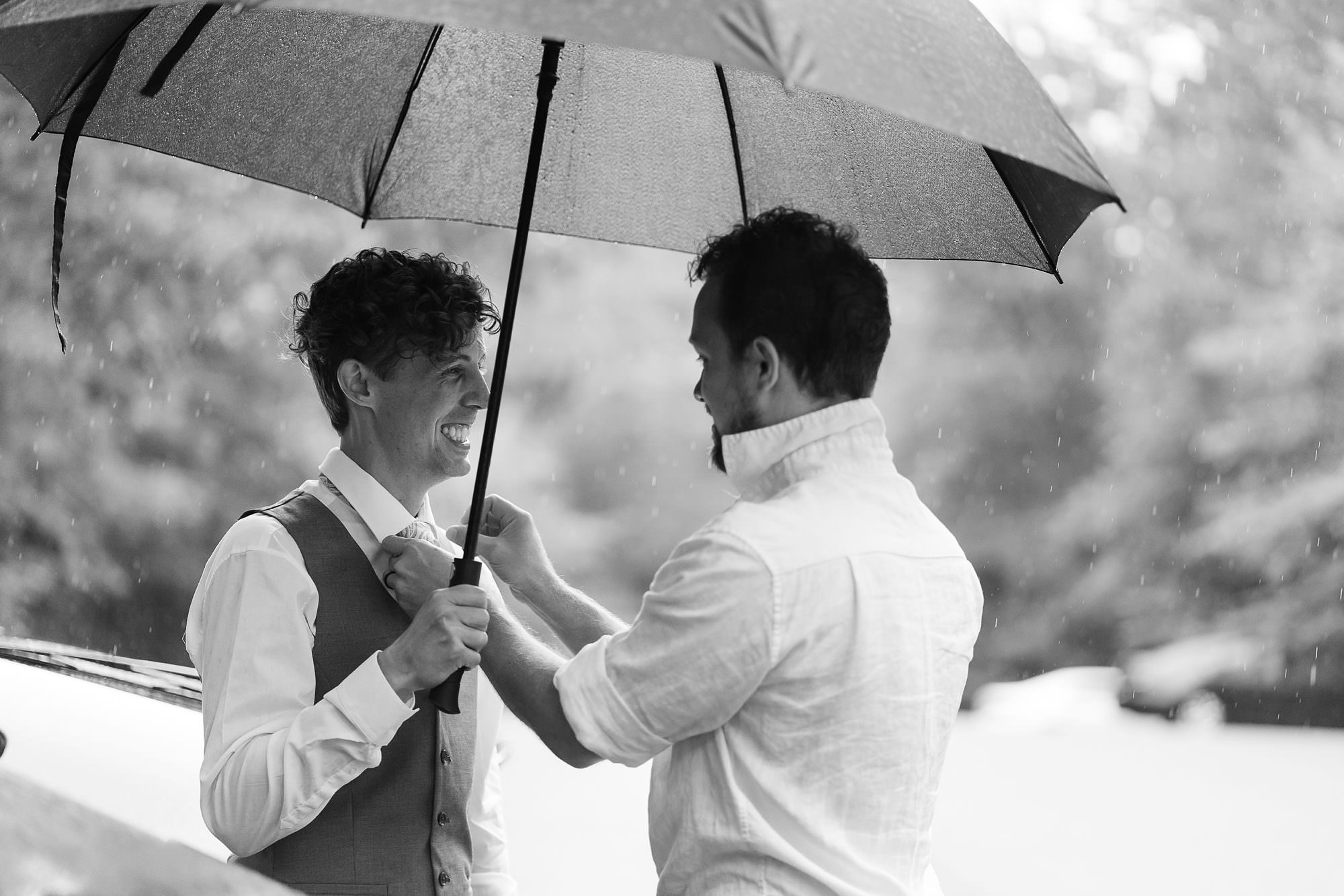 rainy wedding groom umbrella